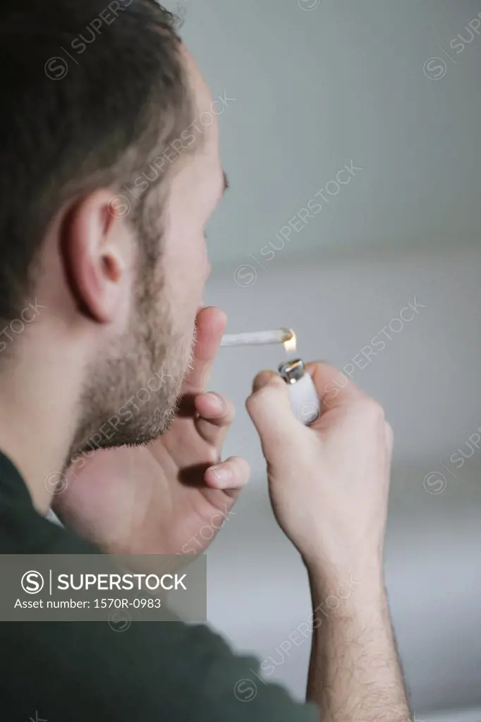 Man lighting marijuana joint