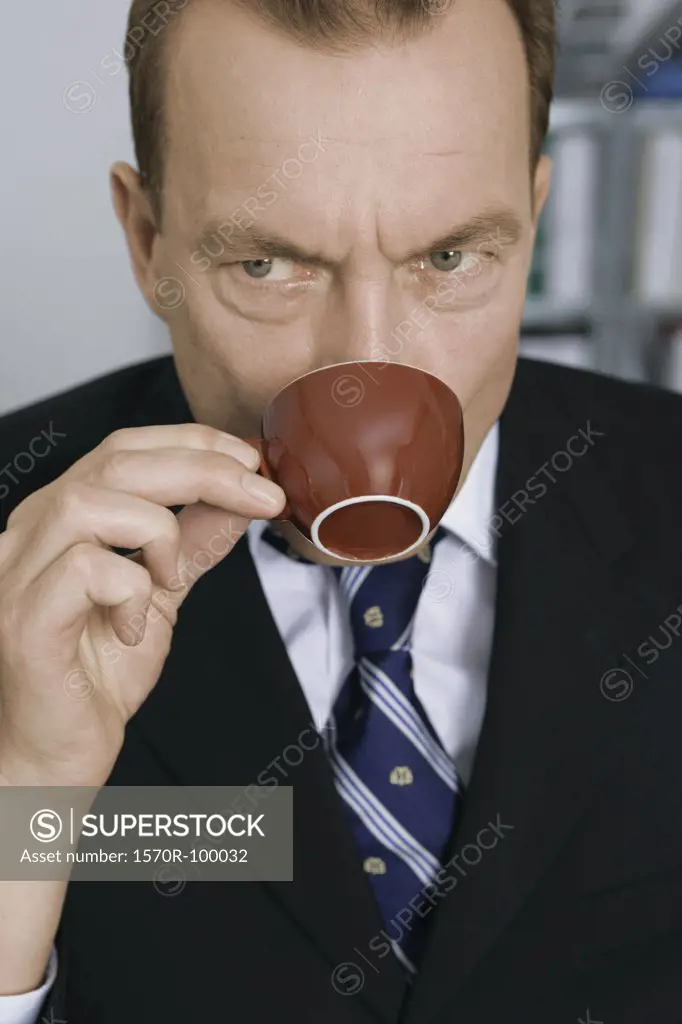 Businessman drinking out of coffee cup