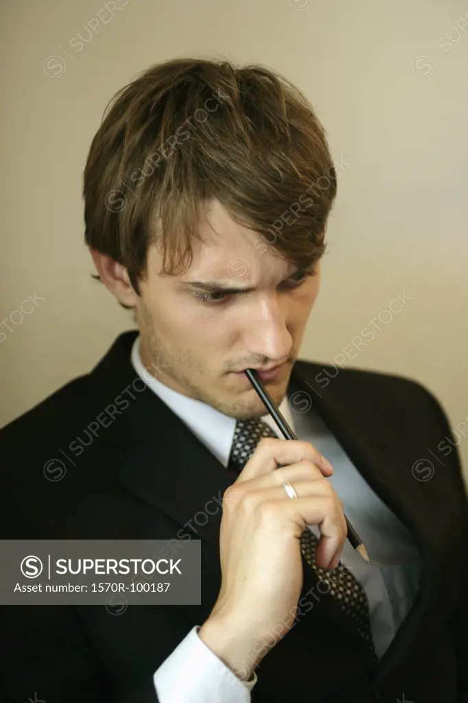 Man with pen in his mouth