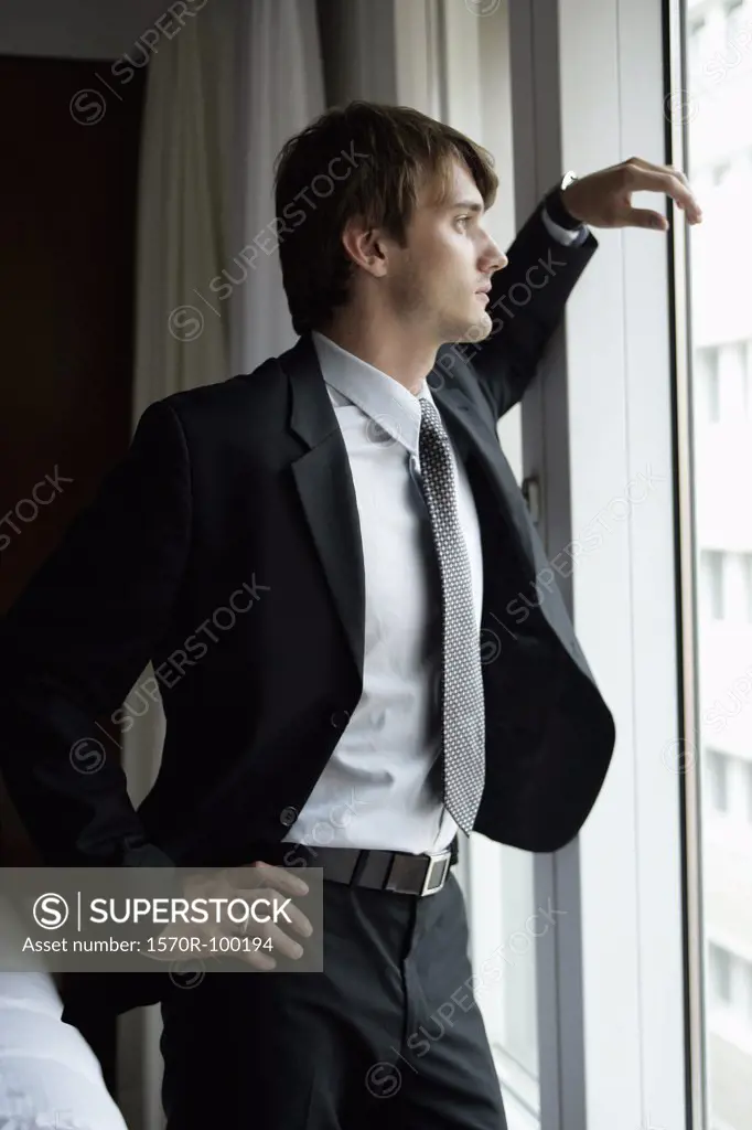 Man in suit standing at window
