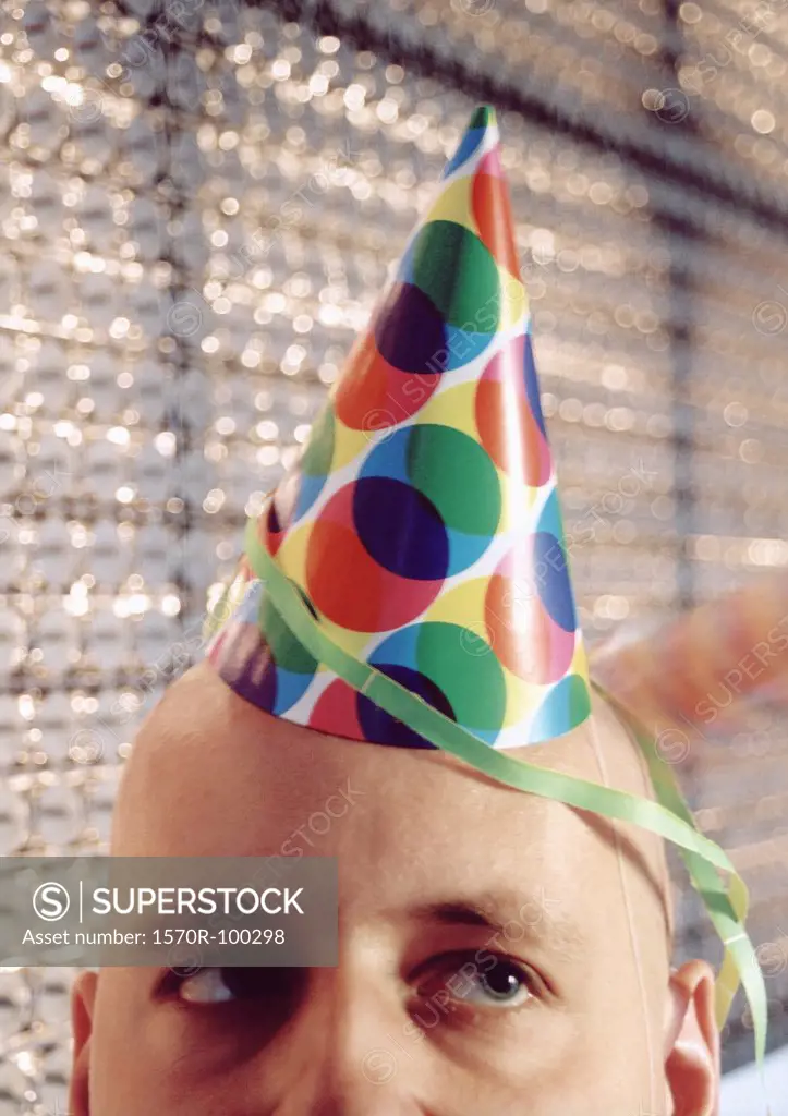 Close-up of man wearing party hat