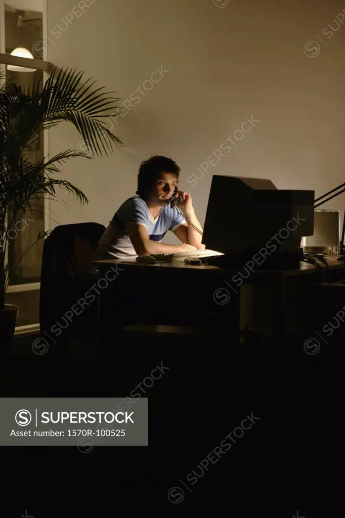Man on telephone, sitting at office desk
