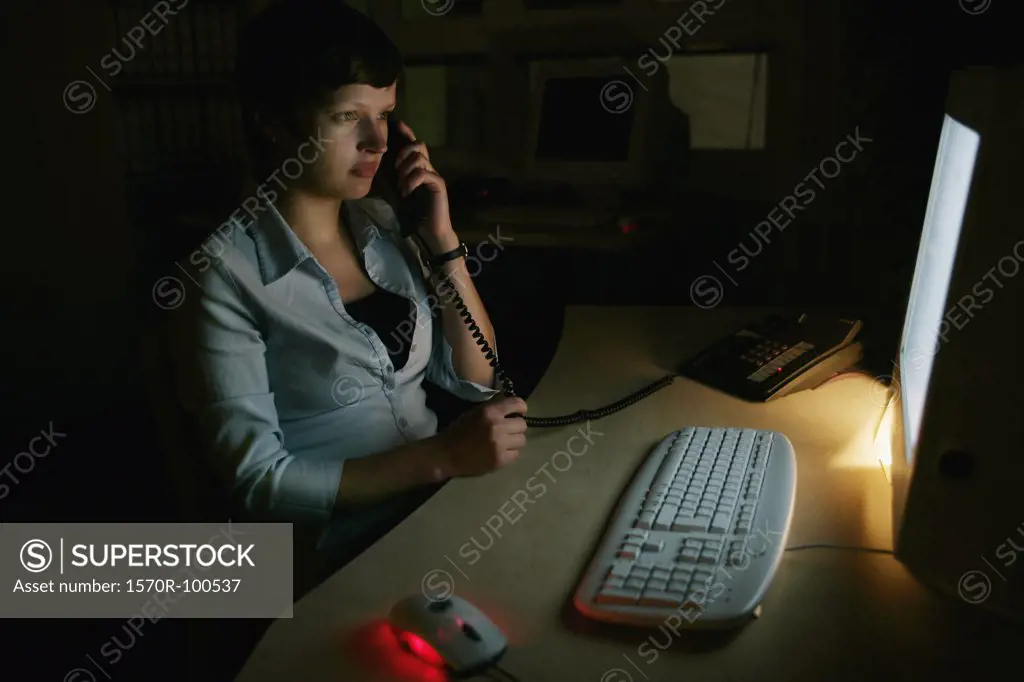 Woman on telephone, sitting at a desk