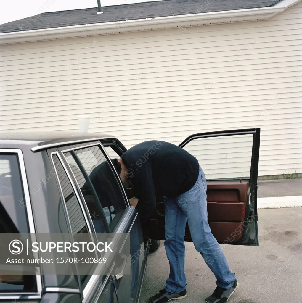 Man leaning into station wagon