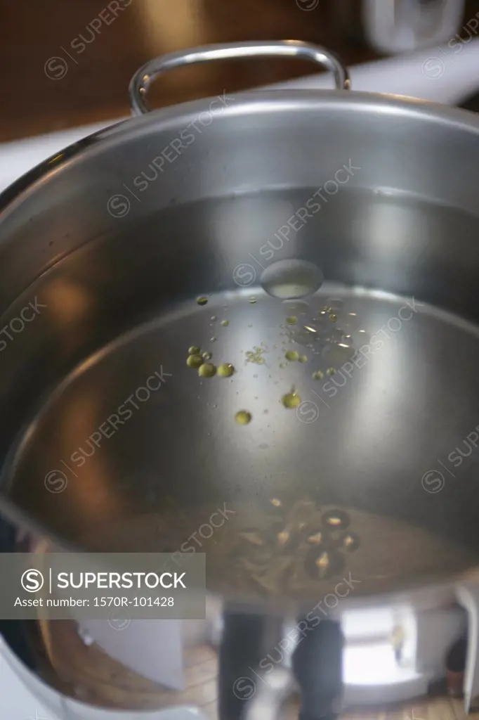 Olive oil in a pot of water