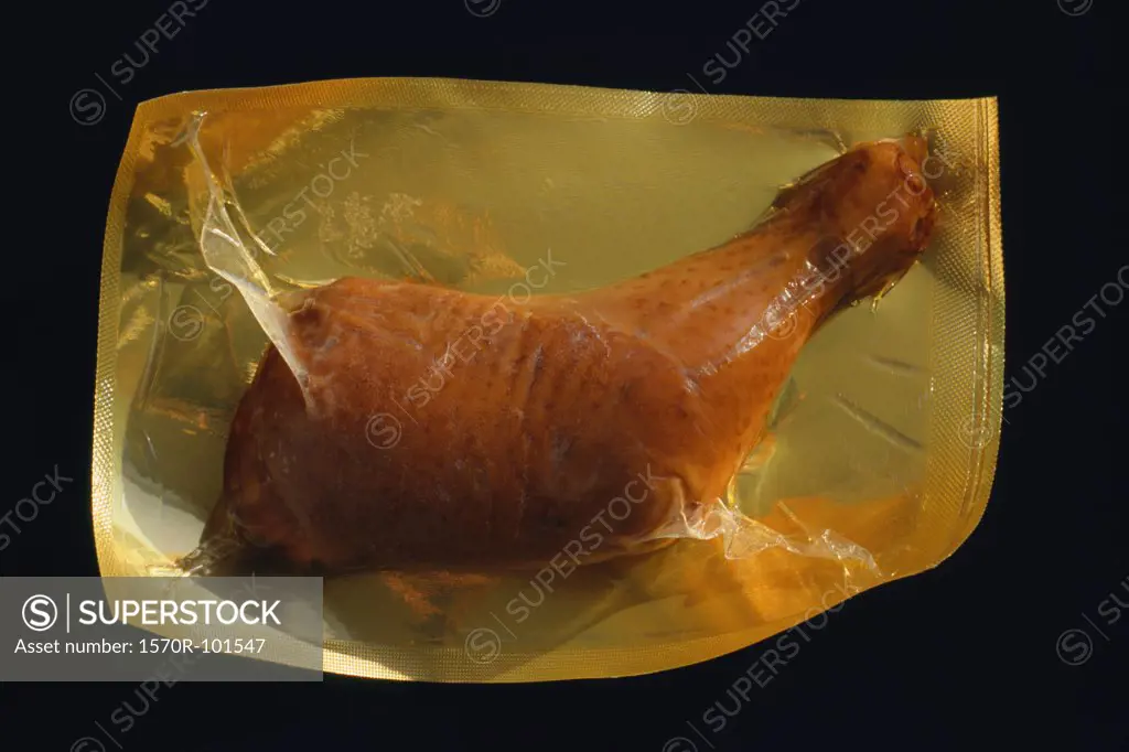 Top view of a piece of chicken packed in plastic