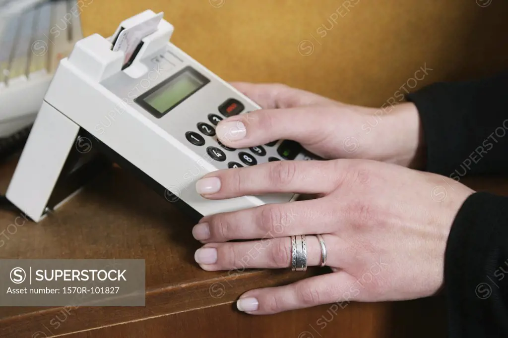 A woman operating a credit card machine