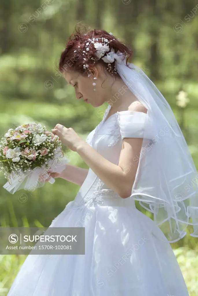 Side view of a bride holding a bouquet