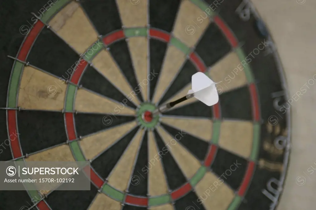 Side view of a dartboard with a dart in the middle