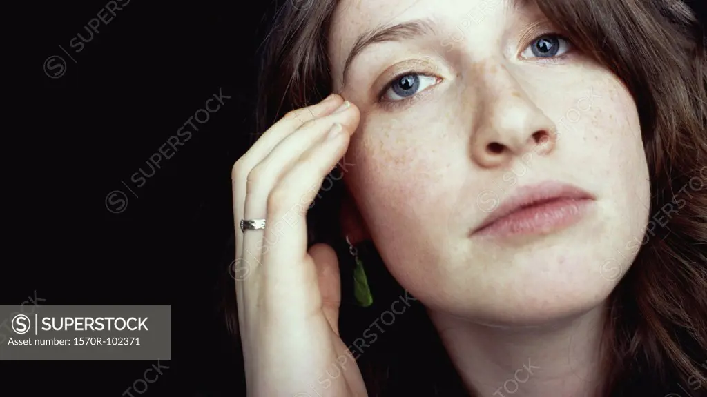 Woman with hand touching face