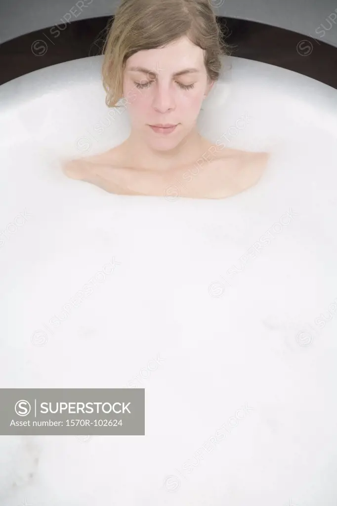 Woman lying in bubble bath