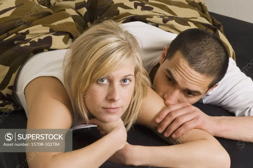 Young couple lying on bed