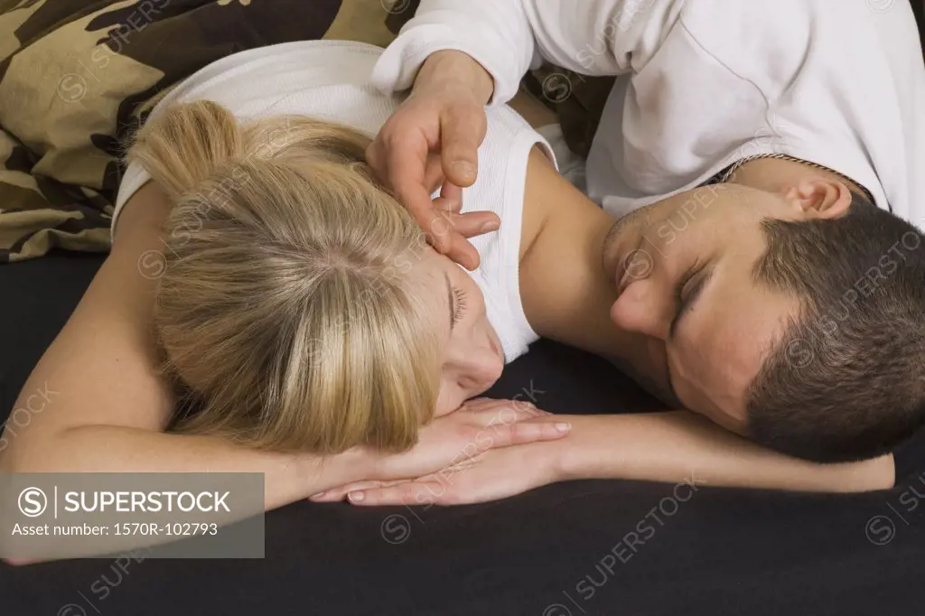 Young couple lying down on bed