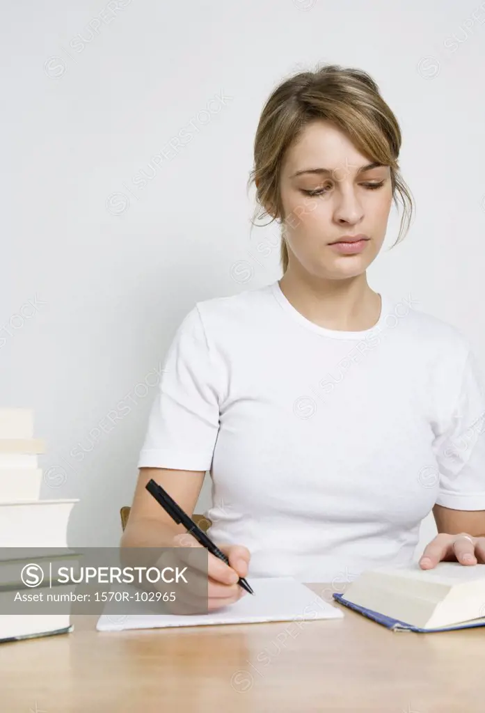 a woman reading and writing