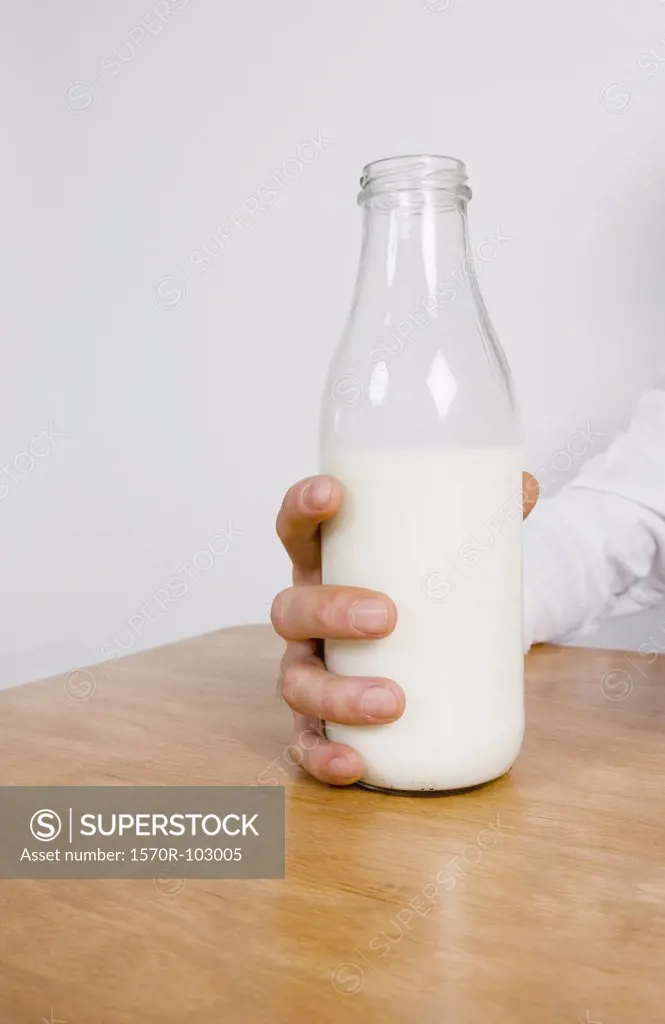 A woman holding a bottle of milk