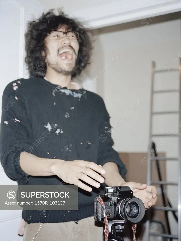 A photographer laughing in a studio