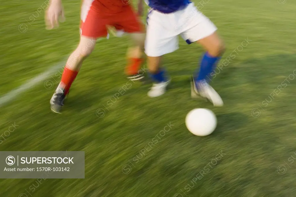 Two people playing soccer