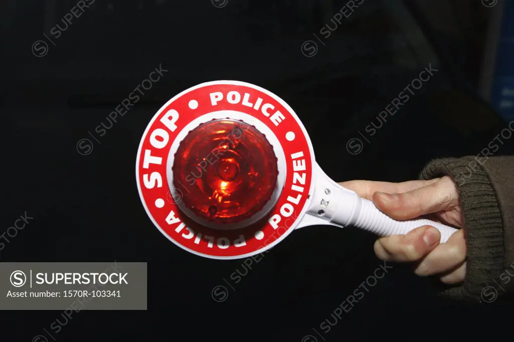 Police officer holding stop sign
