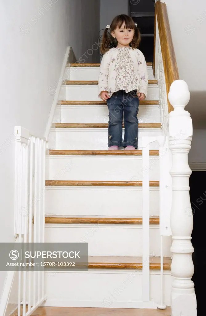 Young girl standing on a staircase