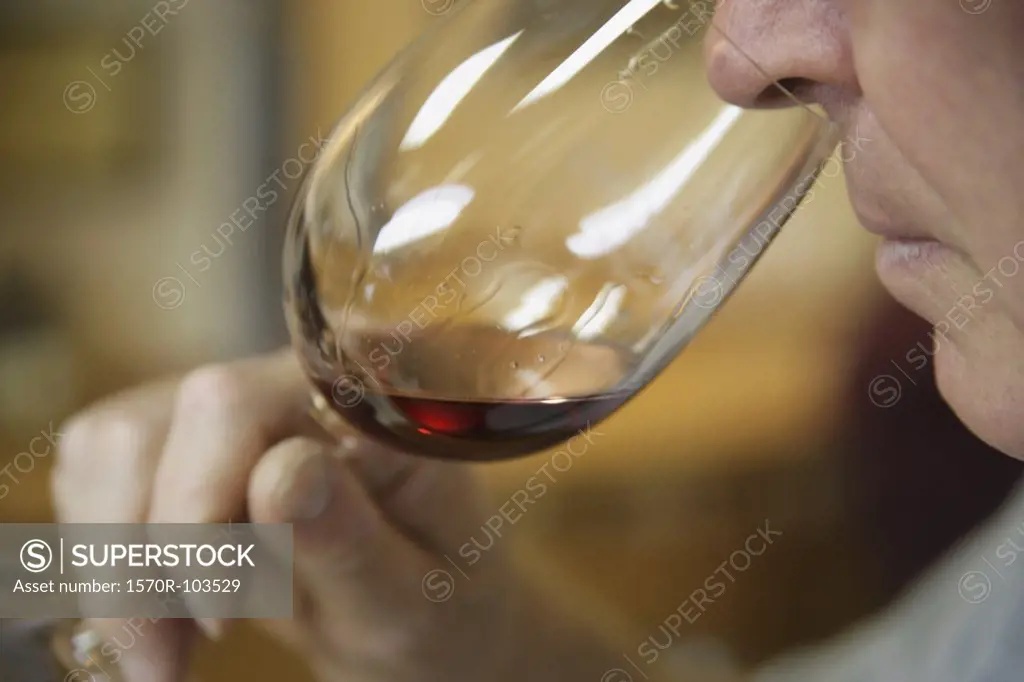 Man smelling a glass of red wine