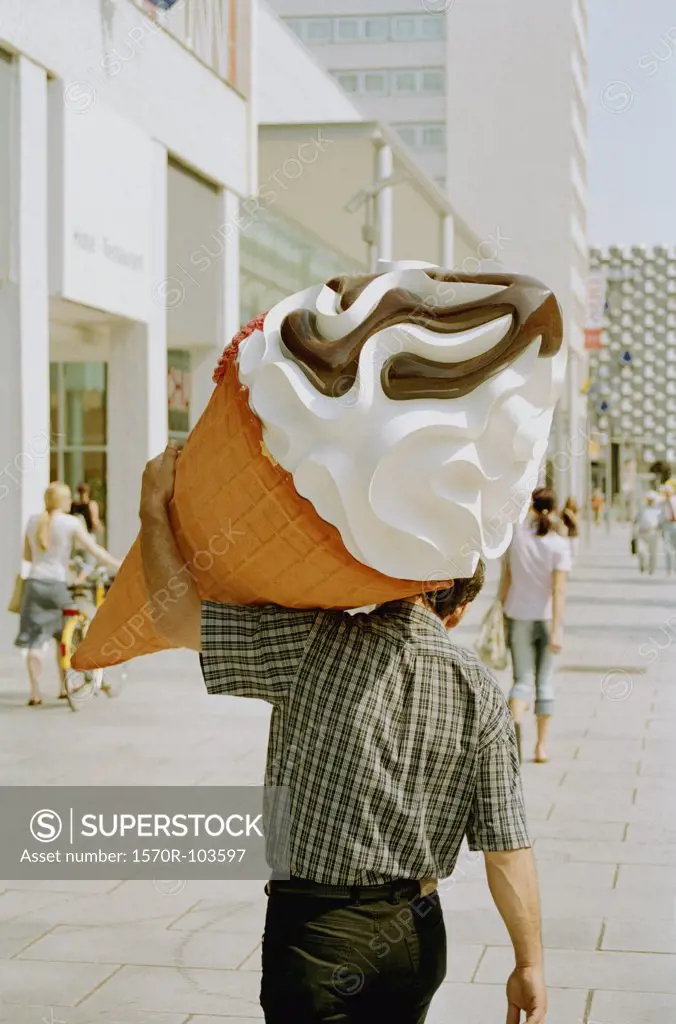 Man carrying large plastic ice cream