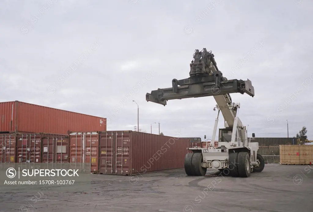 Forklift truck next to cargo containers