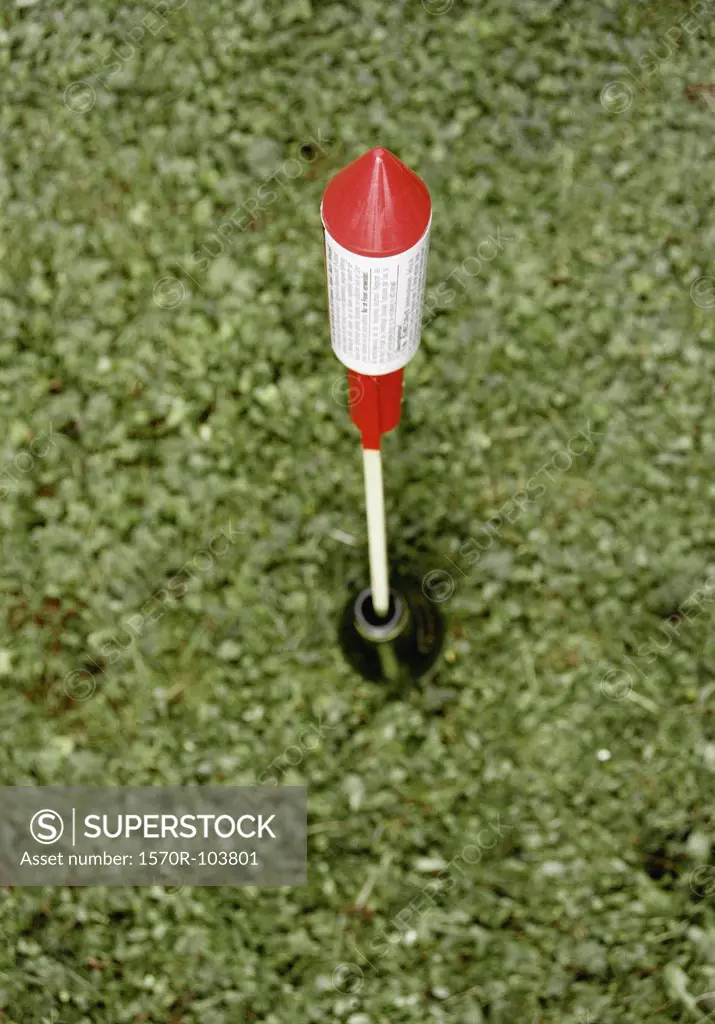 Bottle rocket aimed for launch on grass