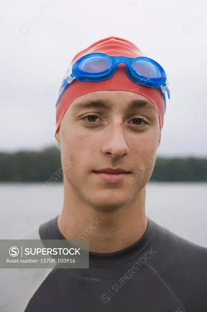Portrait of triathlete wearing swimming goggles and cap
