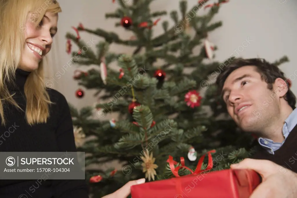 Couple exchanging gift at Christmas