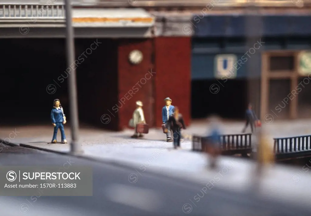 Model of commuters in front of train station