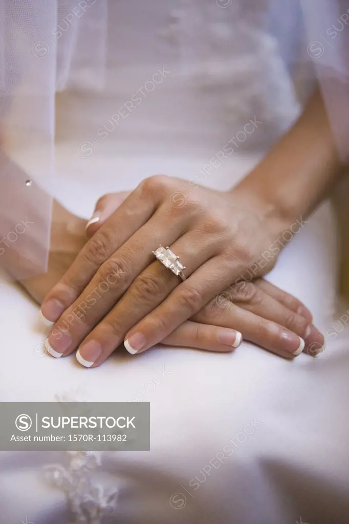 Close-up of brides hands and engagement ring