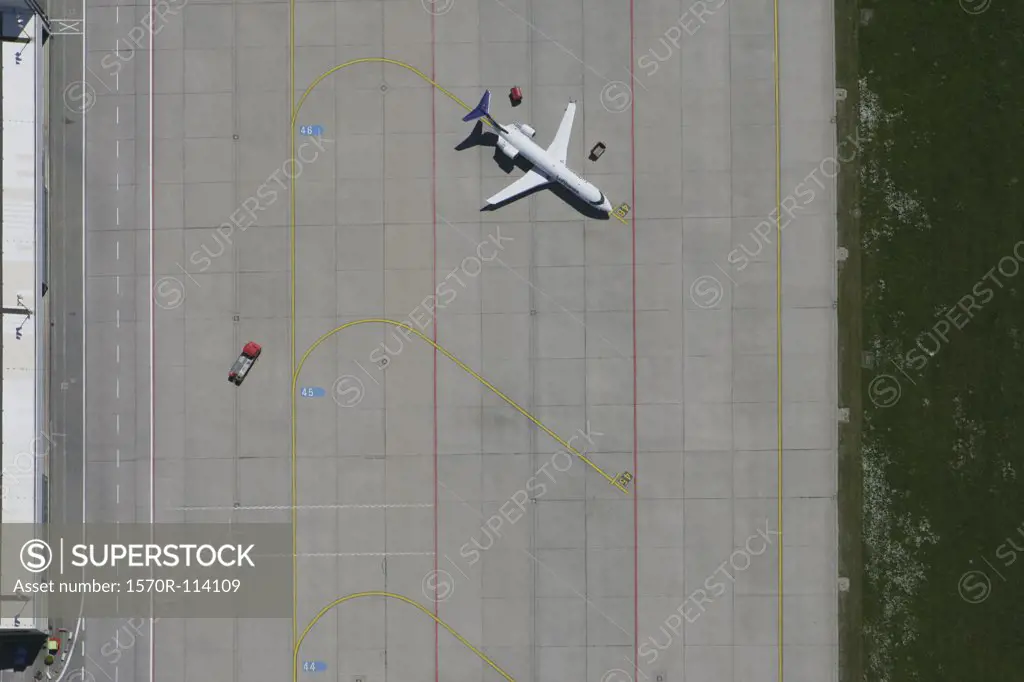 Aerial view of parked plane on airport tarmac