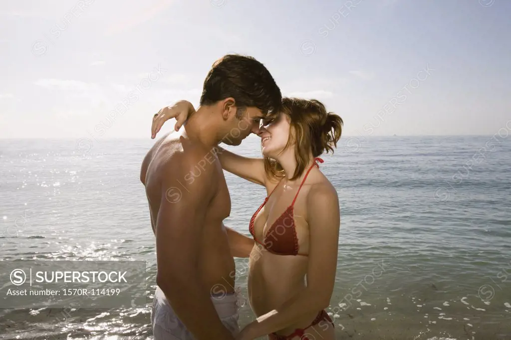 Couple kissing by the sea