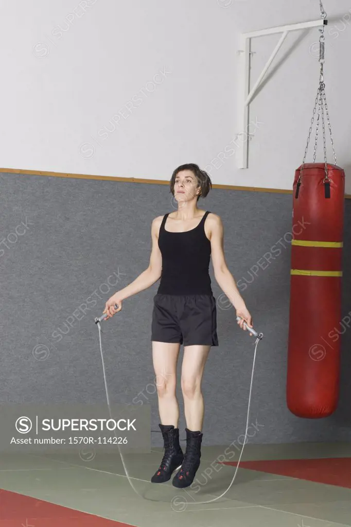 Woman jumping rope in gym