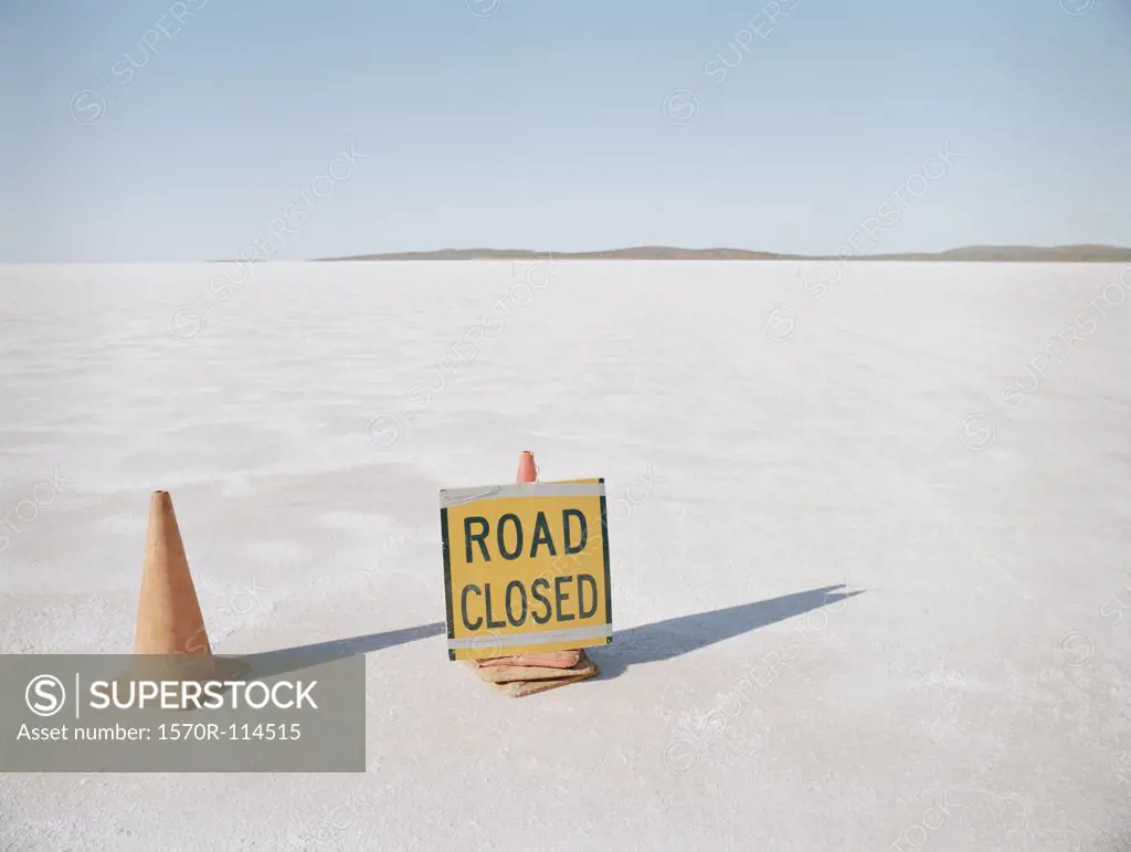 Road Closed’ sign and traffic cones on salt flat