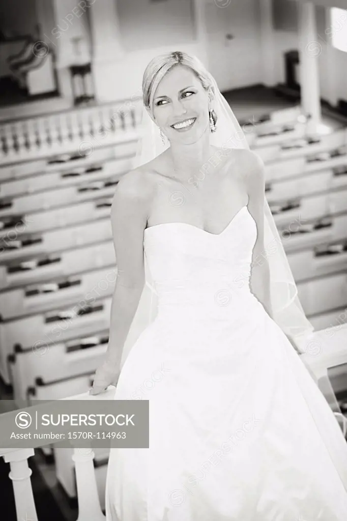 Bride sitting on railing in church stall
