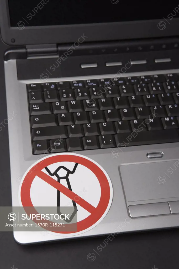 No shirt and tie’ sticker on laptop