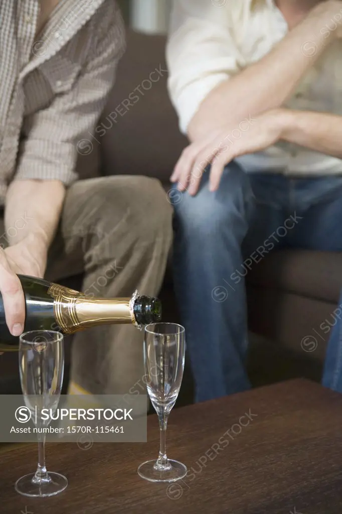 Two men drinking champagne together