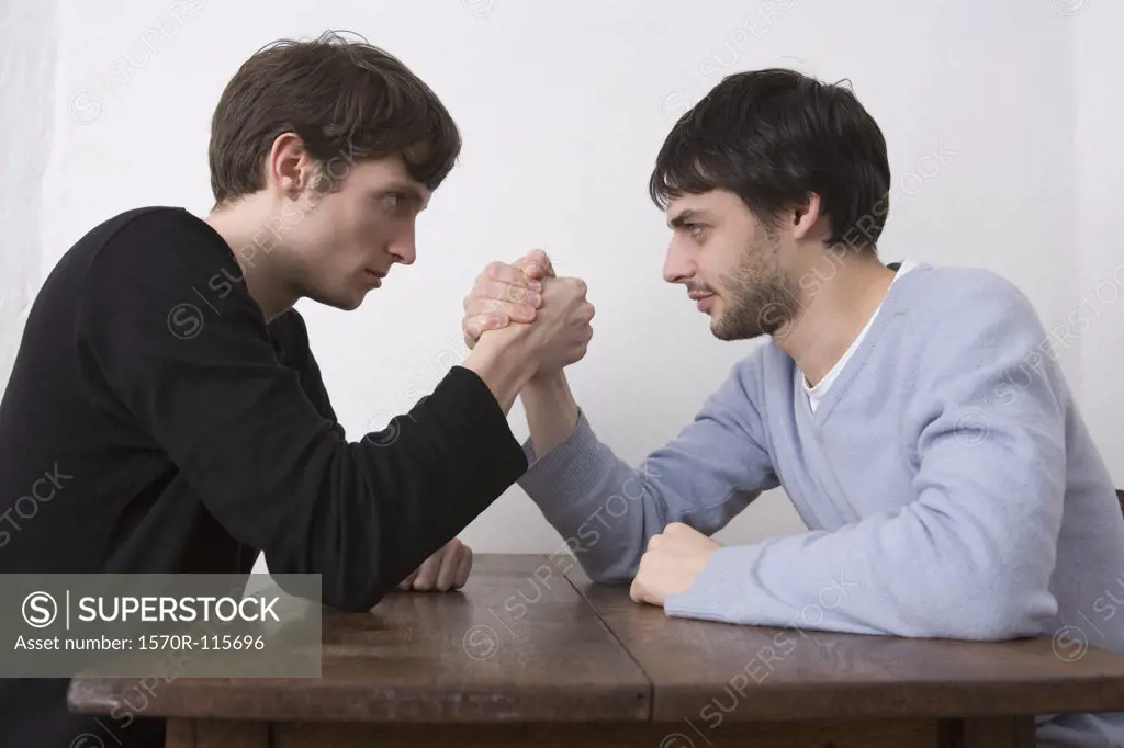 Two young men arm wrestling