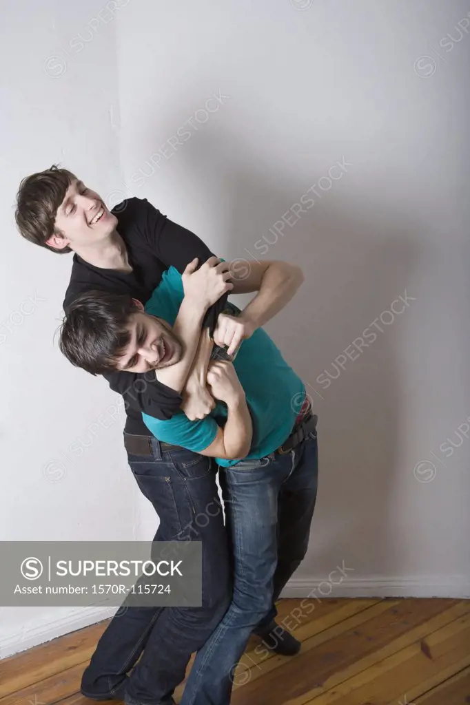 Young gay couple play fighting