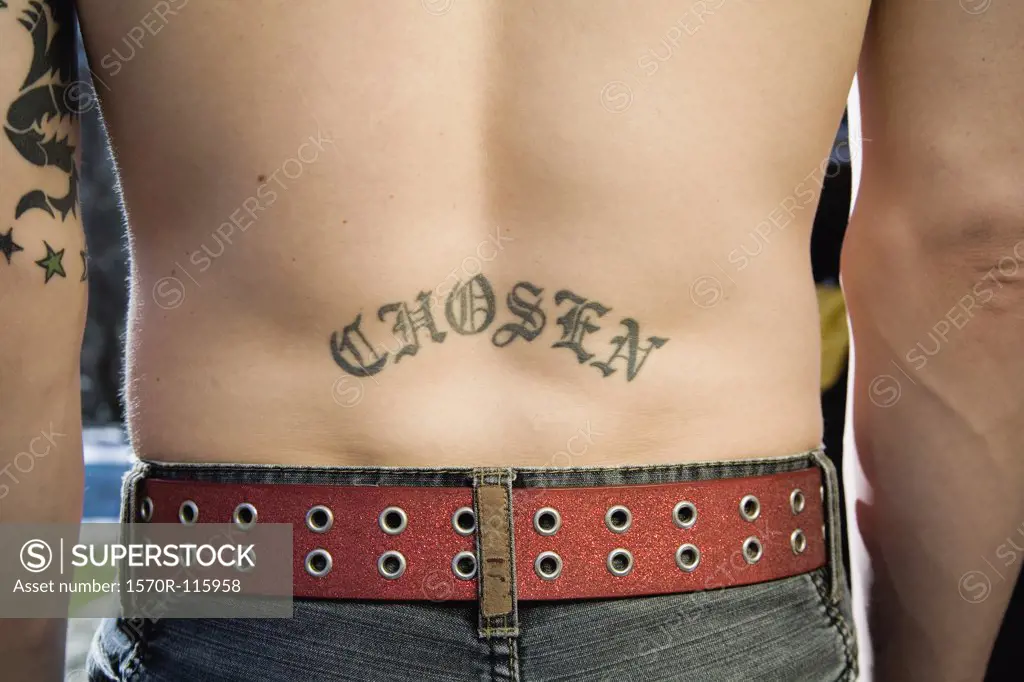 Close-up of a man with chosen’ tattoo on his back