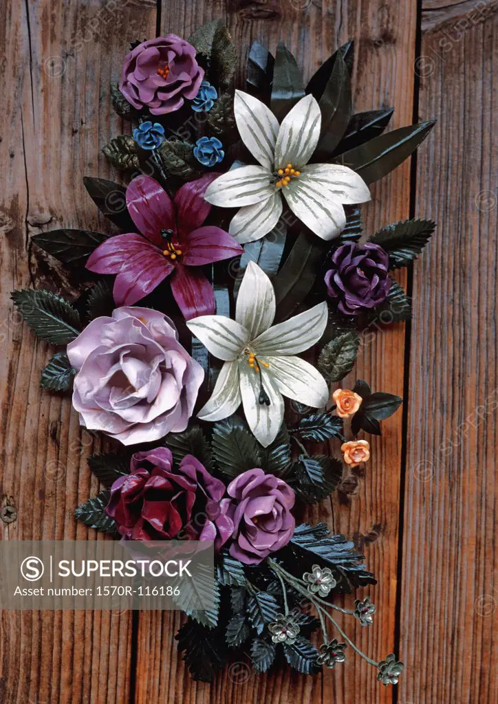 Bouquet of metal flowers attached to a wooden door