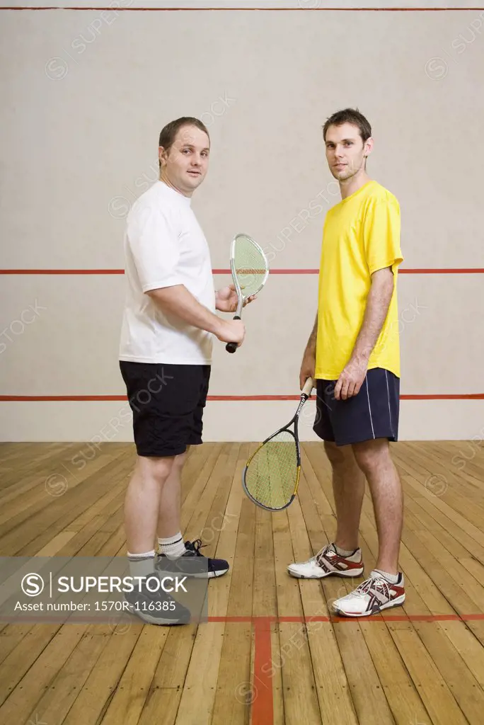 Two men standing on a squash court