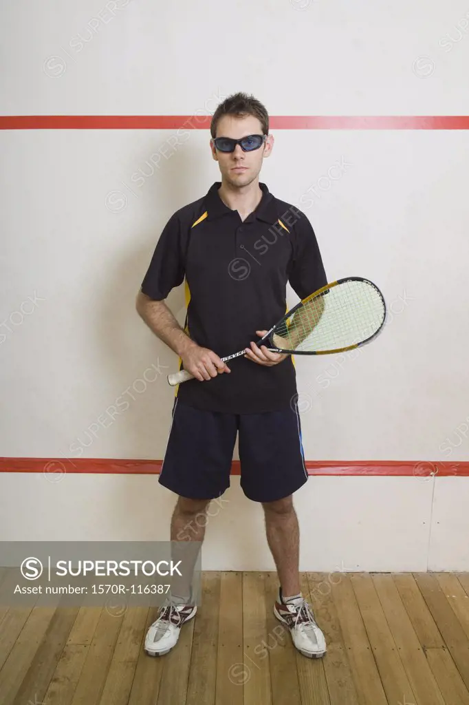 A man standing on a squash court