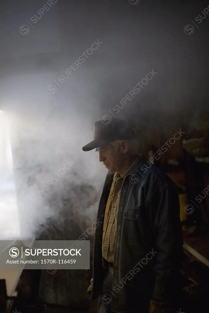 A senior man processing maple sugar