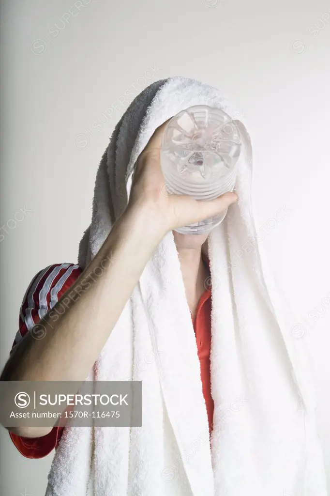 A man drinking from water bottle after exercising