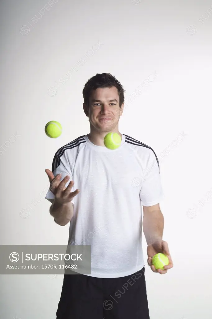 A man juggling with tennis balls