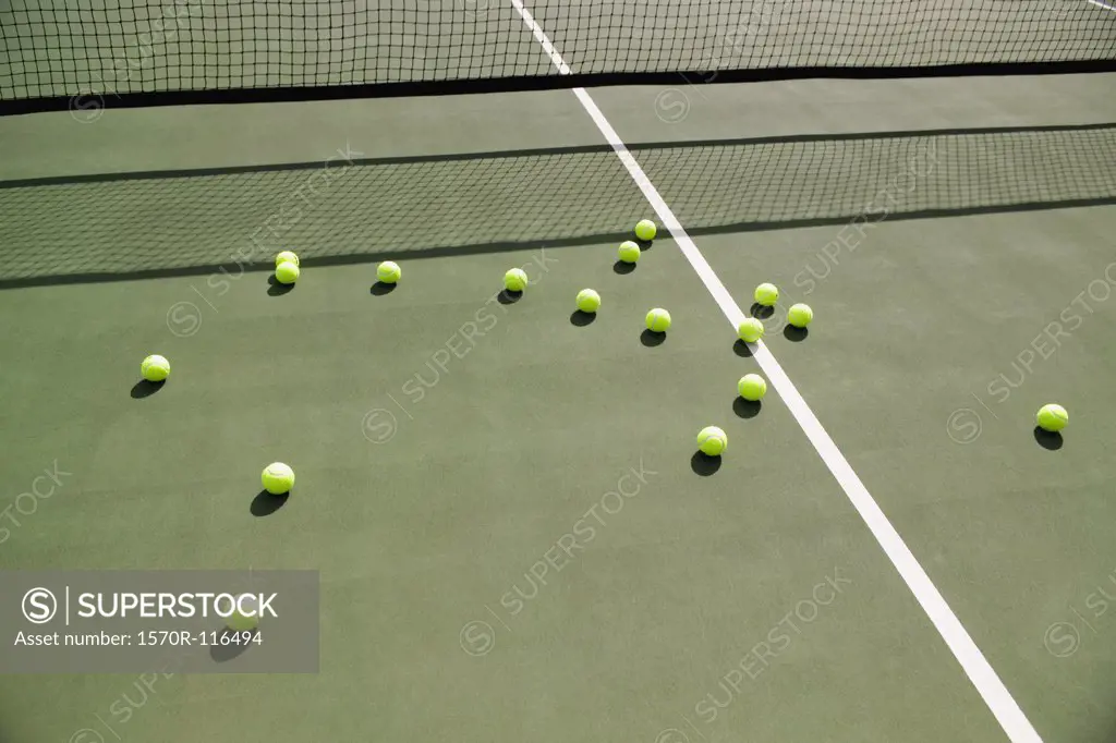 Tennis balls scattered on a tennis court