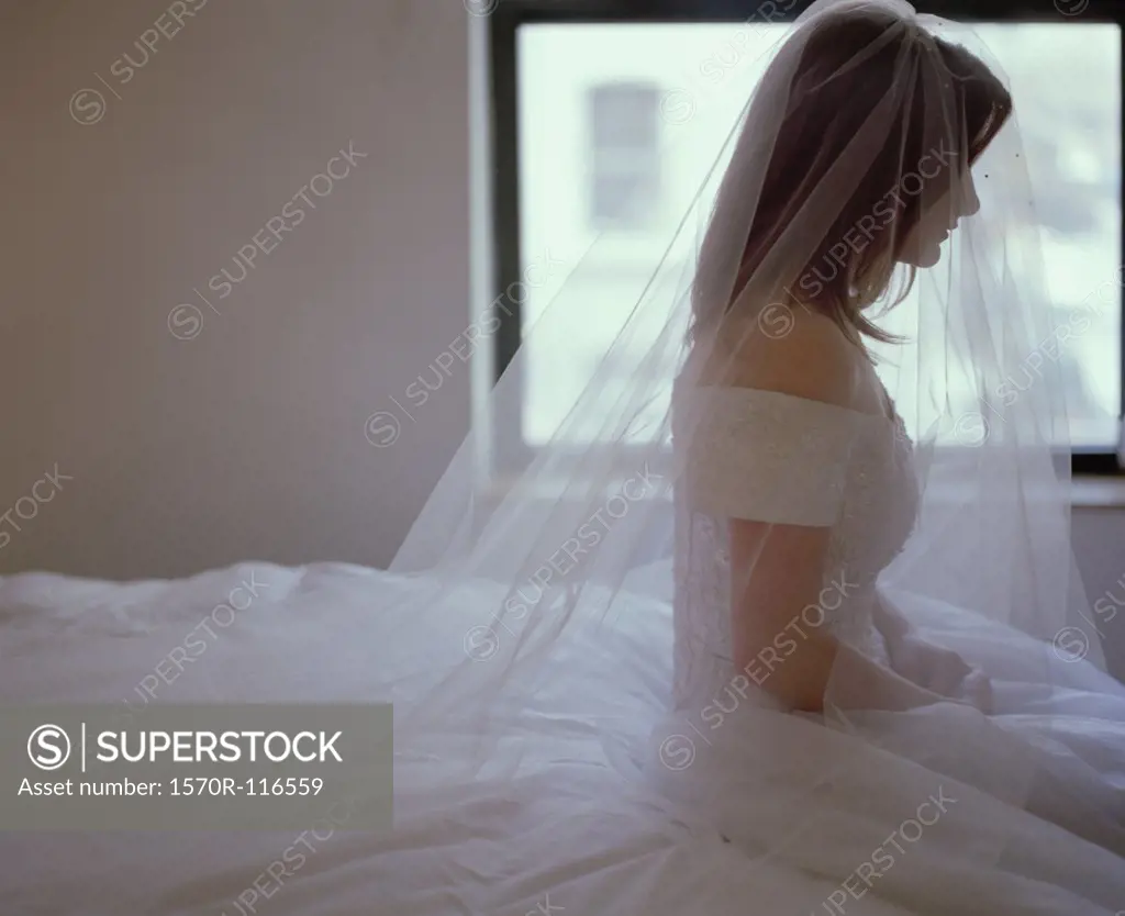 A bride sitting on a bed