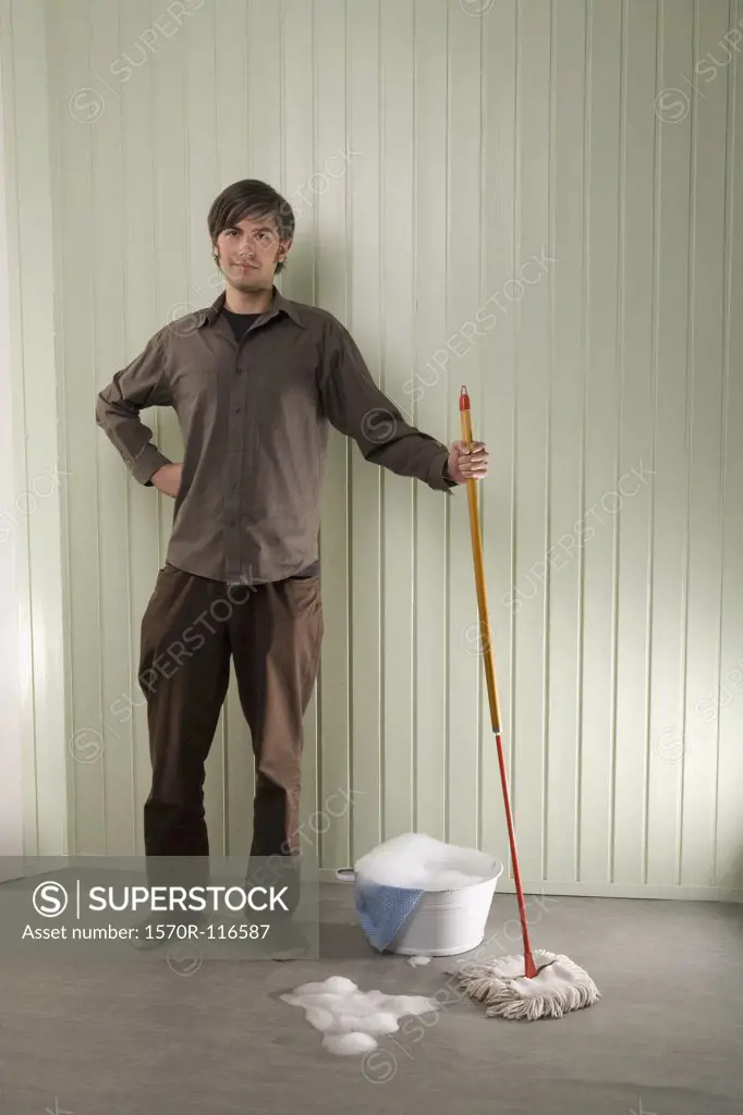 A man standing with a mop and bucket